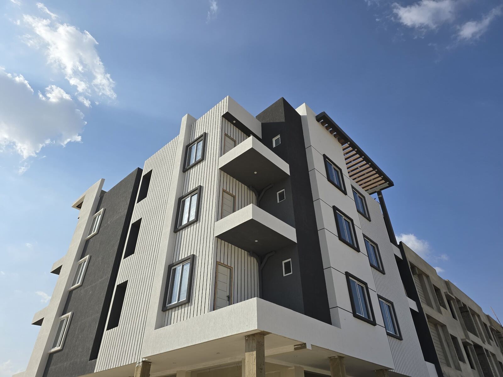 Delivered four-storey shops and apartments building